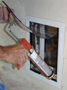 Caulk tunnel walls of pet door tunnel to attach carpet